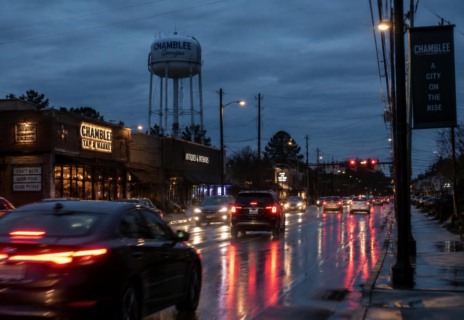 Evening traffic on a wet main road through downtown Chamblee, Georgia beneath the Chamblee water tower